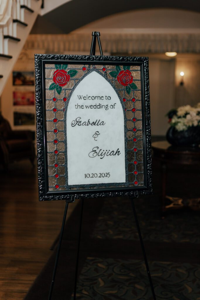 Romantic stained glass wedding welcome sign at Black Swan Country Club in Georgetown, Massachusetts.