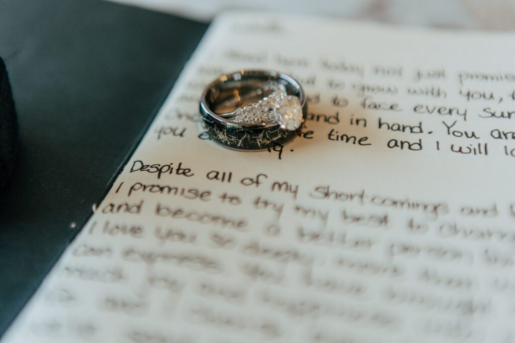 Close up of wedding rings and hand written vows at Black Swan Country Club in Georgetown, Massachusetts.