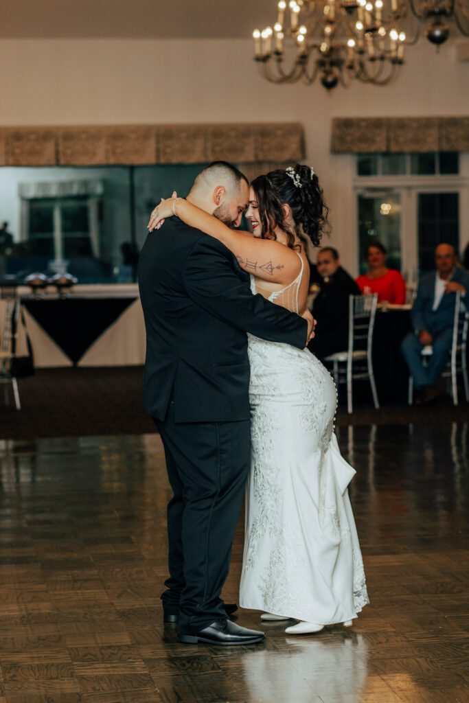 Bride and groom sharing their romantic first dance during wedding
reception at Black Swan Country Club in Georgetown, Massachusetts.