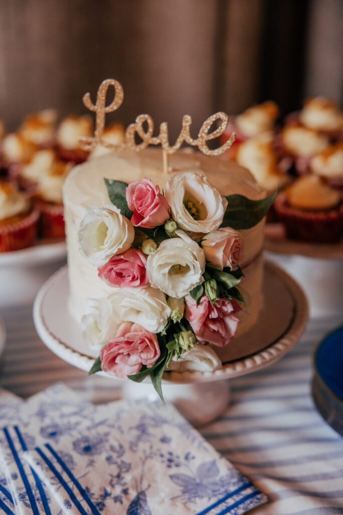 Wedding cake that says "Love" for elopement at Bird park in Walpole, Massachusetts..