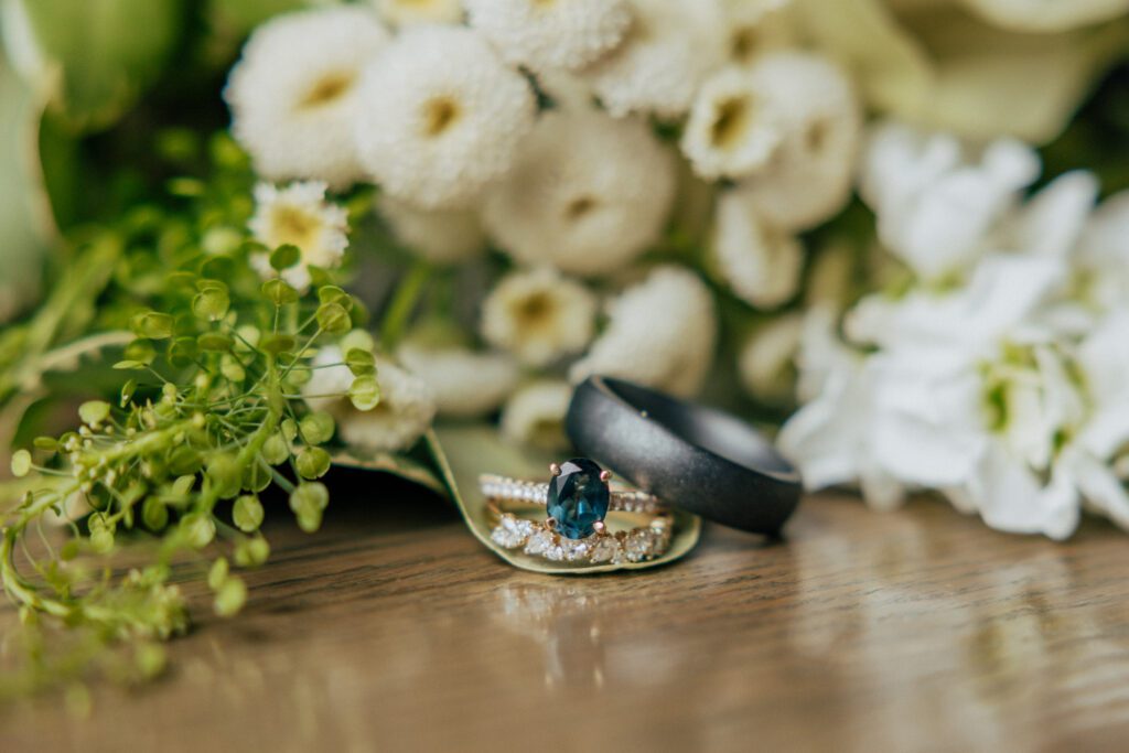 Close up of blue wedding ring in flower bouquet at Bird Park in Walpole, Massachusetts.