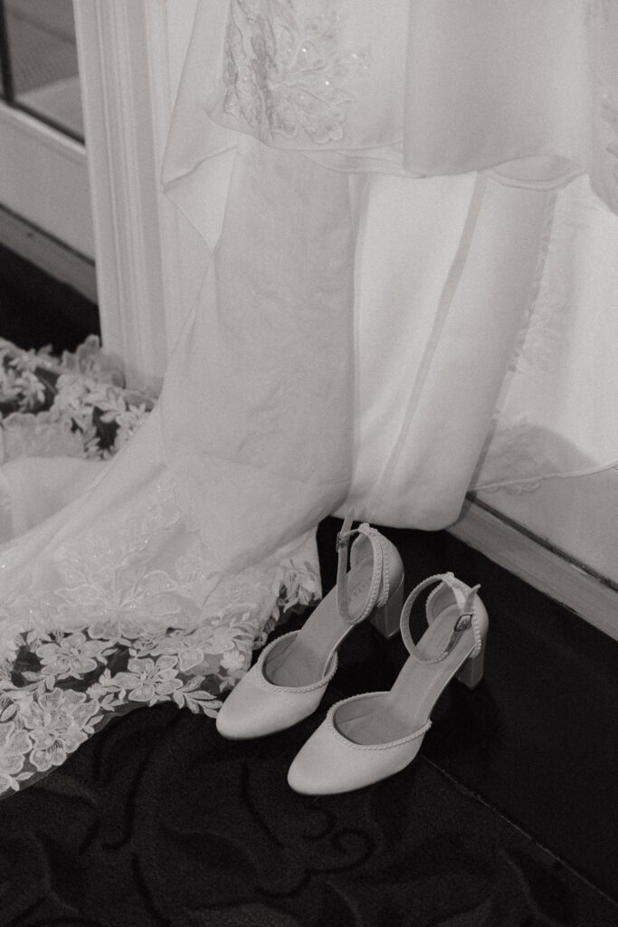 Close up of wedding dress train and wedding shoes at Black Swan Country Club in Georgetown, Massachusetts.