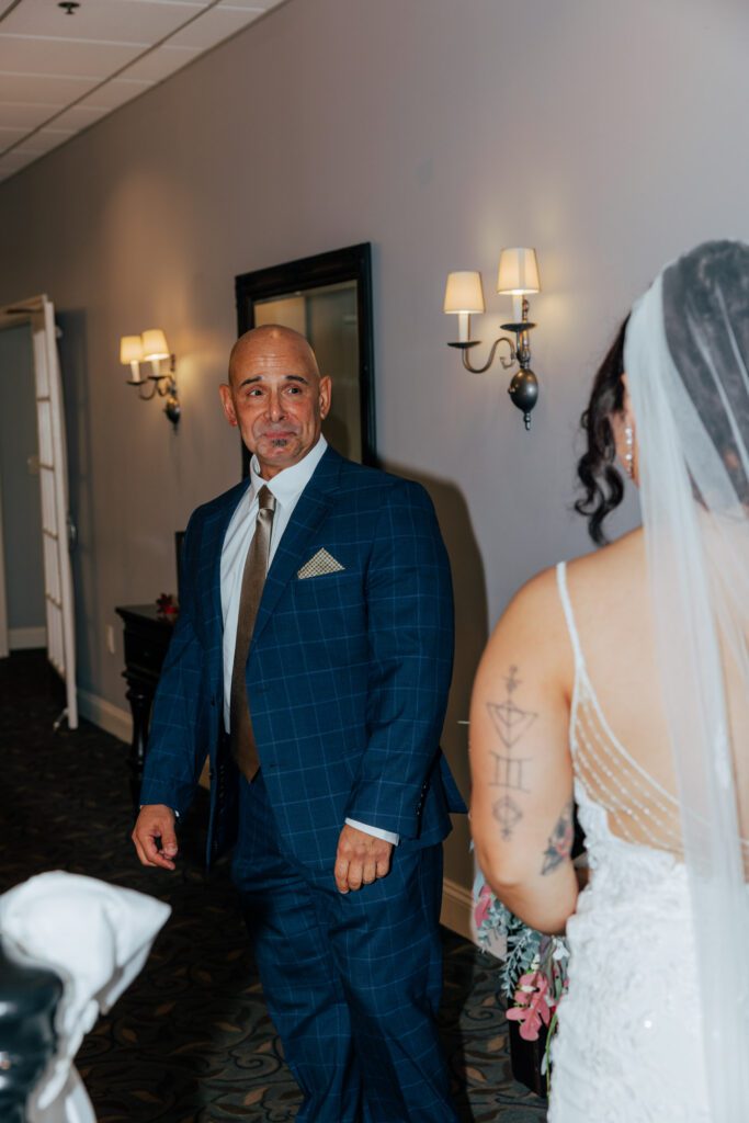 A father's reaction to first look with a bride at Black Swan Country Club in Georgetown, Massachusetts.