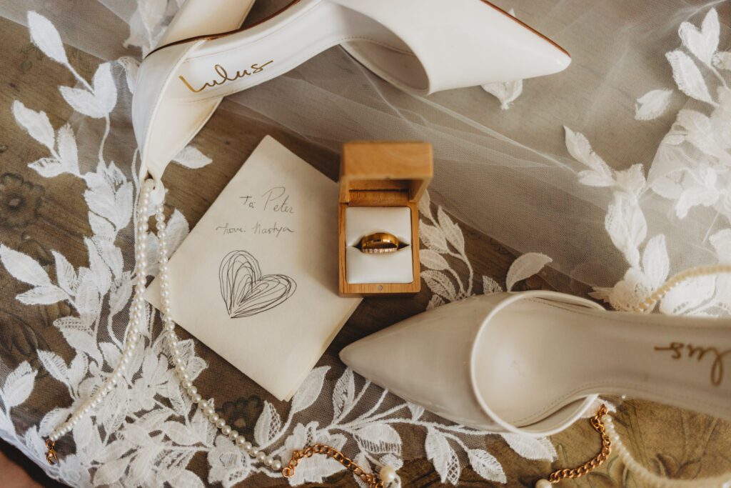 Close up of vows, shoes, and rings at The Evermore at Peirce Farm Estate in Topsfield, Massachusetts .