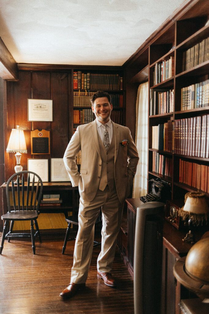 Groom smiling with hands in pockets at The Evermore at Peirce Farm Estate in Topsfield, Massachusetts.