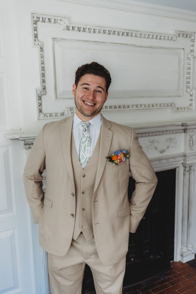 Groom smiling while getting ready at The Evermore at Peirce Farm Estate in Topsfield, Massachusetts.