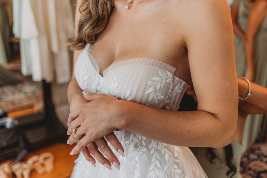 Close of a brides dress details and nails as she gets ready at The Evermore at Peirce Farm Estate in Topsfield, Massachusetts.