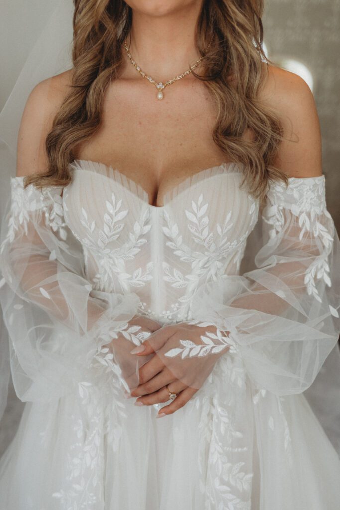 Closeup of brides dress, and necklace in the bridal suit at The Evermore at Peirce Farm Estate in Topsfield, Massachusetts.
