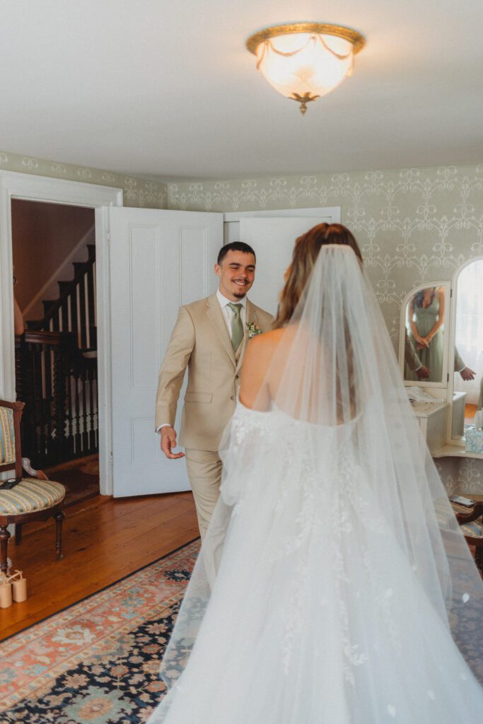 Bride's brother walking towards bride during a first look at The Evermore at Peirce Farm Estate in Topsfield, Massachusetts.