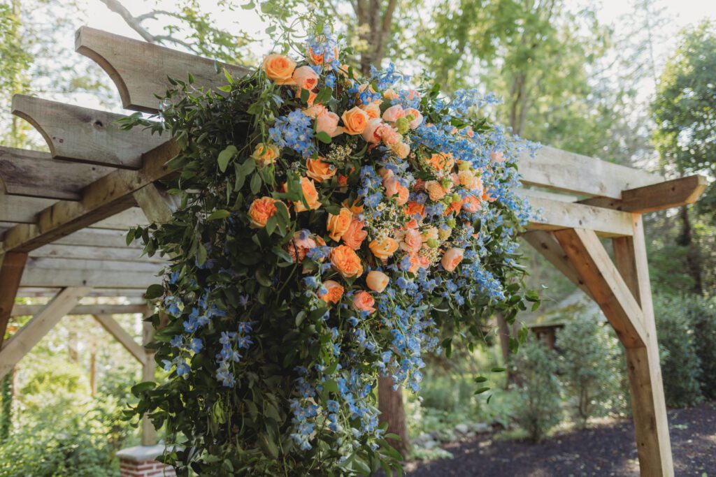 A whimsical summer flower arch for outdoor ceremony at Peirce Farm Estate in Topsfield, Massachusetts.