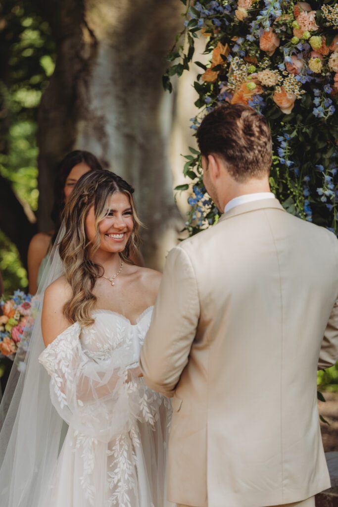 Bride smiling at groom during romantic outdoor wedding in the summer at Peirce Farm Estate in Topsfield, Massachusetts.