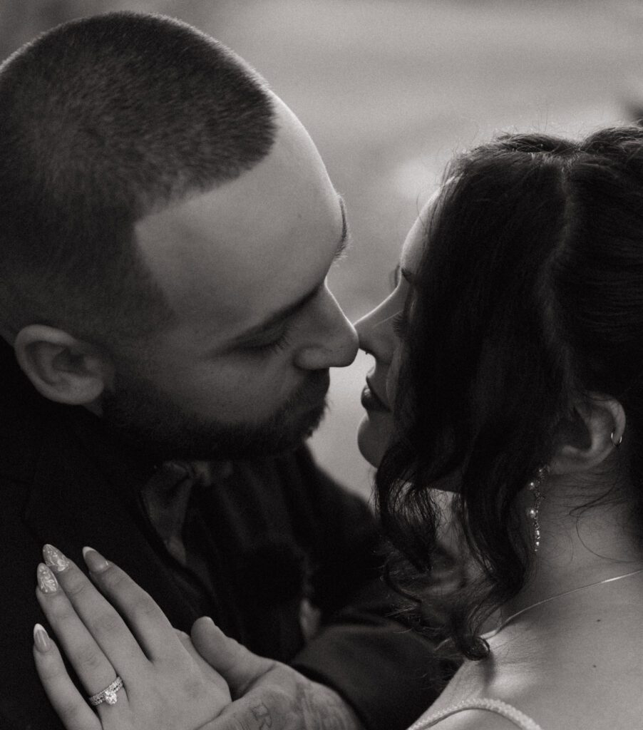 Romantic close up of Bride and Groom touching noses outside at Black Swan Country Club in Georgetown, Massachusetts.