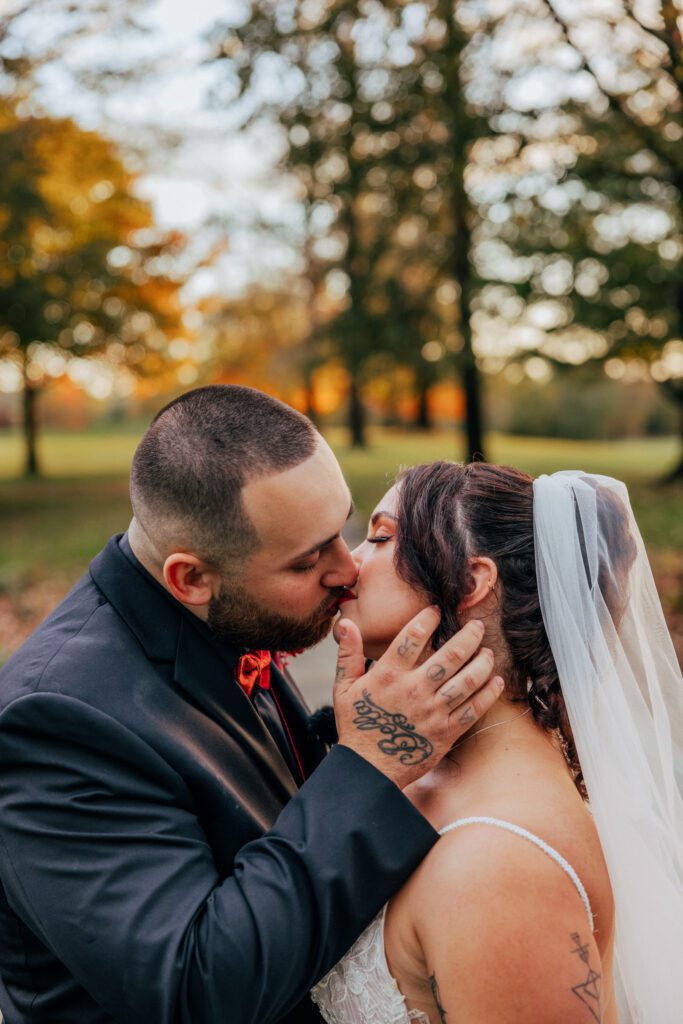 Close up of bride and groom kissing during fall wedding at Black Swan Country Club in Georgetown, Massachusetts.