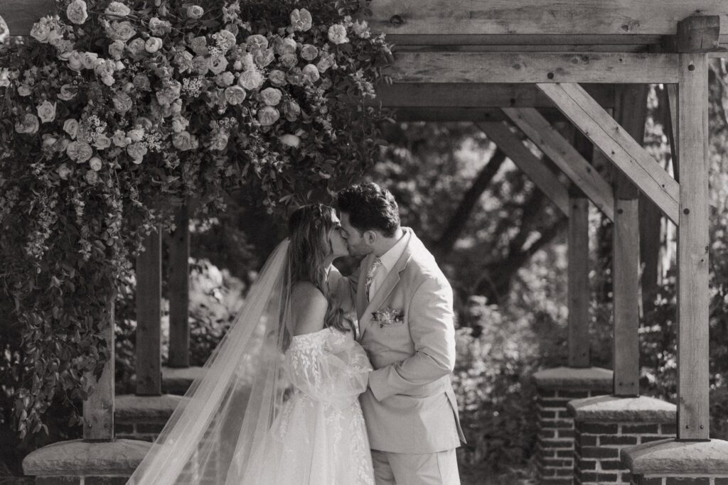 Bride and groom share a kiss during their outdoor fairytale wedding at Peirce Farm Estate in Topsfield, Massachusetts.