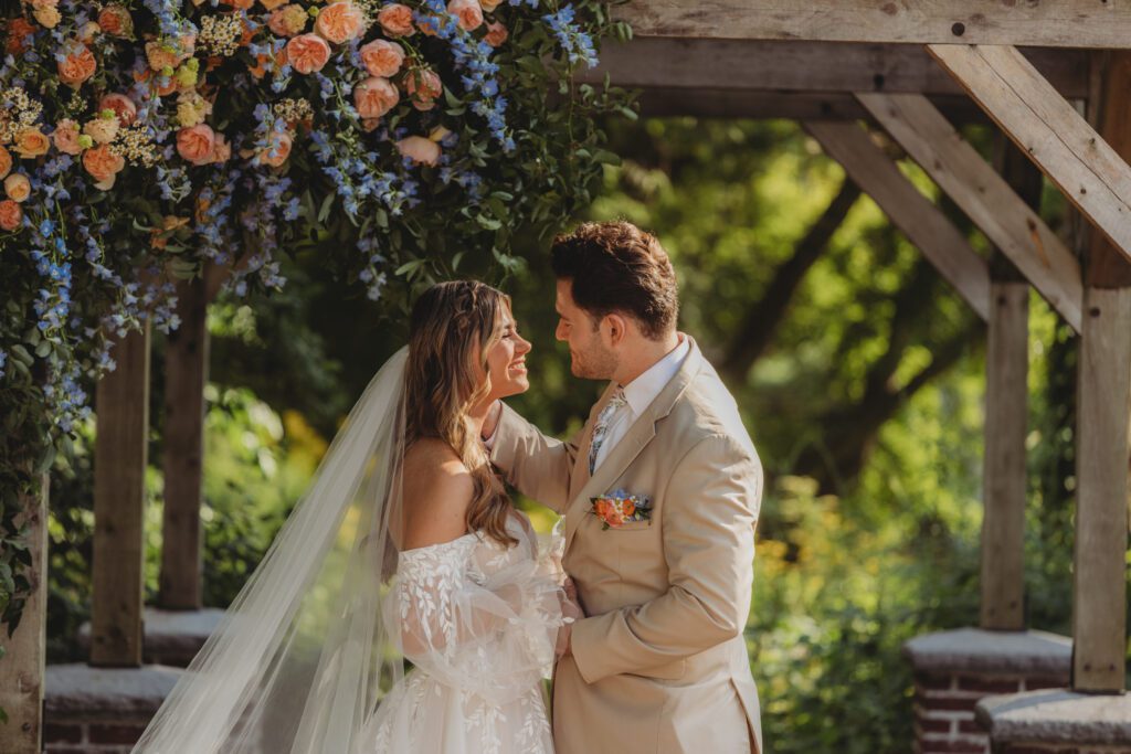 Bride and groom look at each other after thier first kiss smiling at Peirce Farm Estate in Topsfield, Massachusetts.