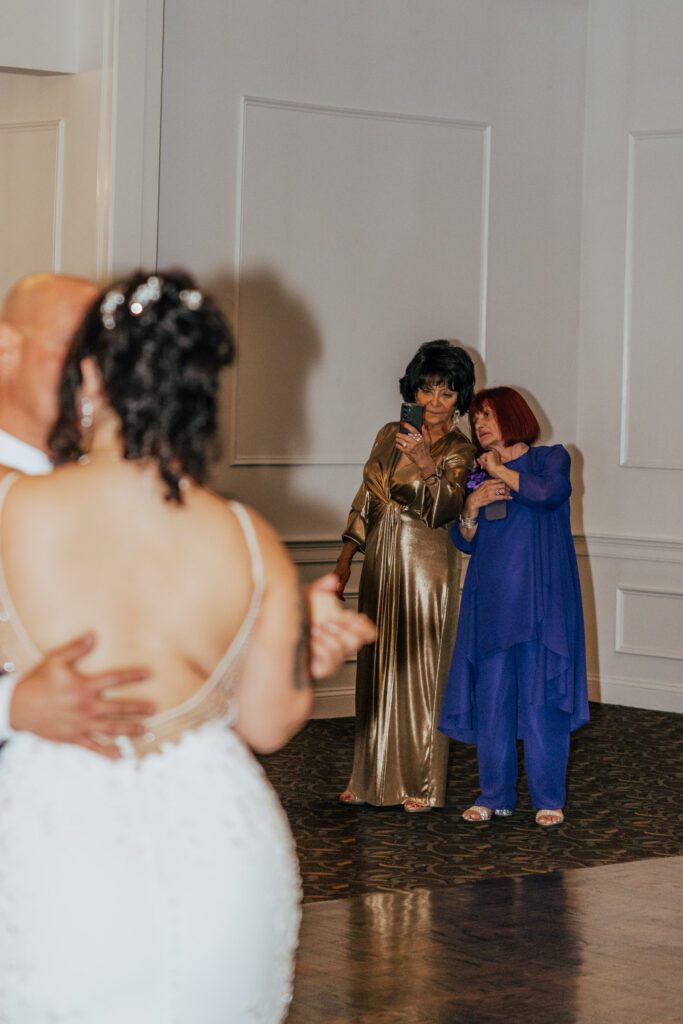 Guests photographing father daughter dance during reception at Black Swan Country Club in Georgetown, Massachusetts.