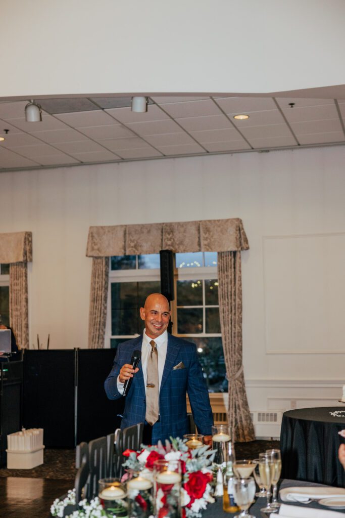 Father of the bride smiling during his speech during wedding reception at Black Swan Country Club in Georgetown, Massachusetts.