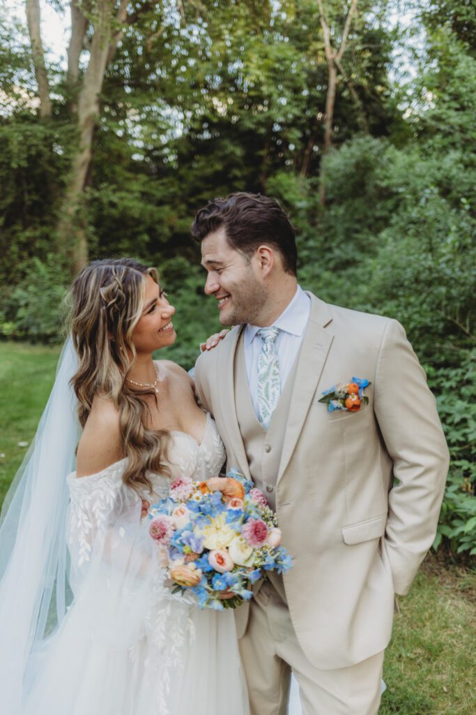 Close up of a bride and groom smiling at each other a fairytale summer wedding at Peirce Farm Estate in Topsfield, Massachusetts.