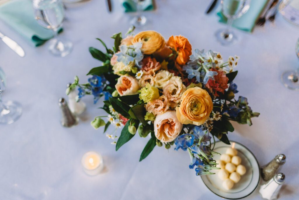 Flower arrangement for charming barn wedding reception at Peirce Farm Estate in Topsfield, Massachusetts.
