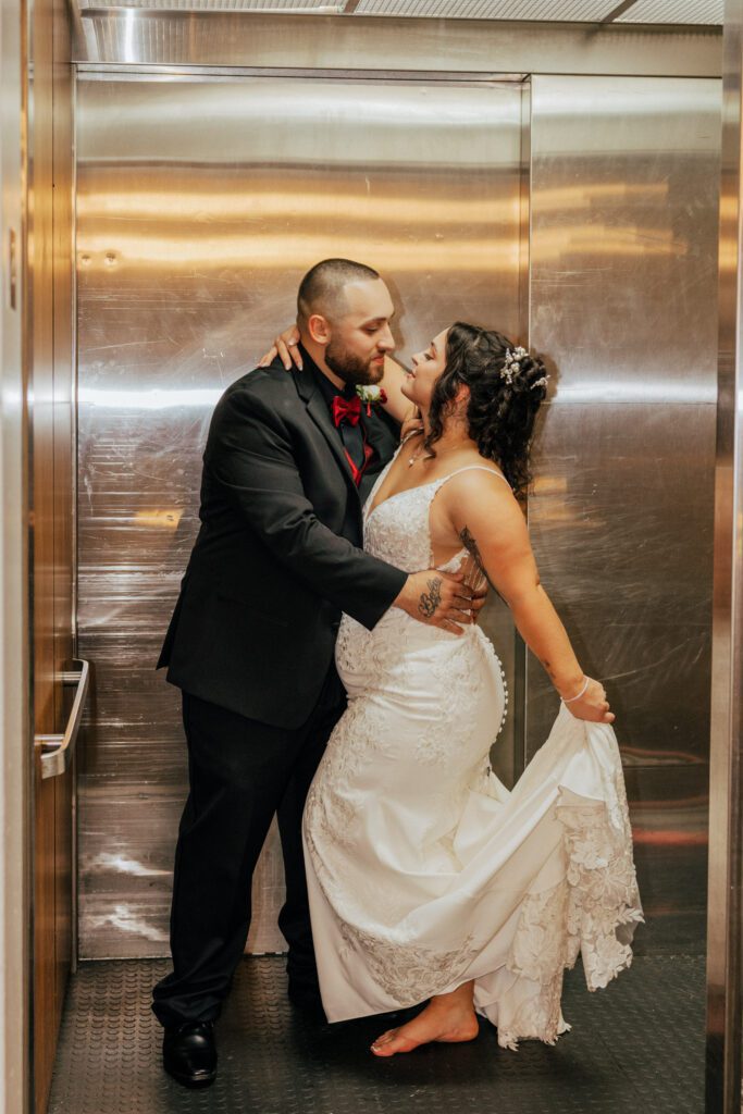 Bride and groom romantically looking at each other on an elevator during reception at Black Swan Country Club in Georgetown, Massachusetts.