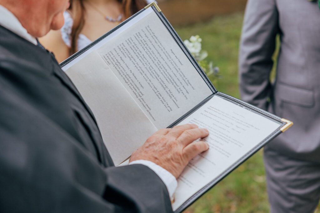 Officiant reading vows at summer elopement at Bird Park in Walpole, Massachusetts.