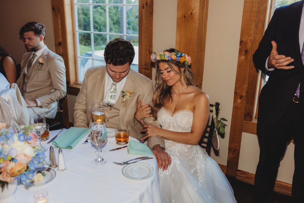 Bride and groom praying during romantic barn reception at Peirce Farm Estate in Topsfield, Massachusetts.