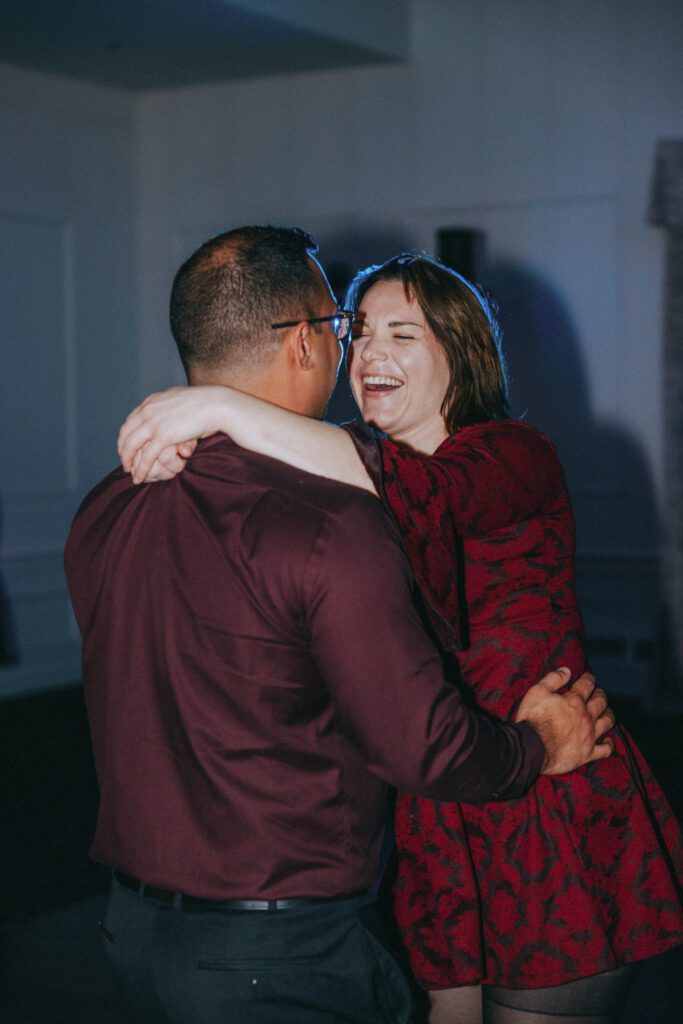 Guests laughing while dancing a classy reception at Black Swan Country Club in Georgetown, Massachusetts.