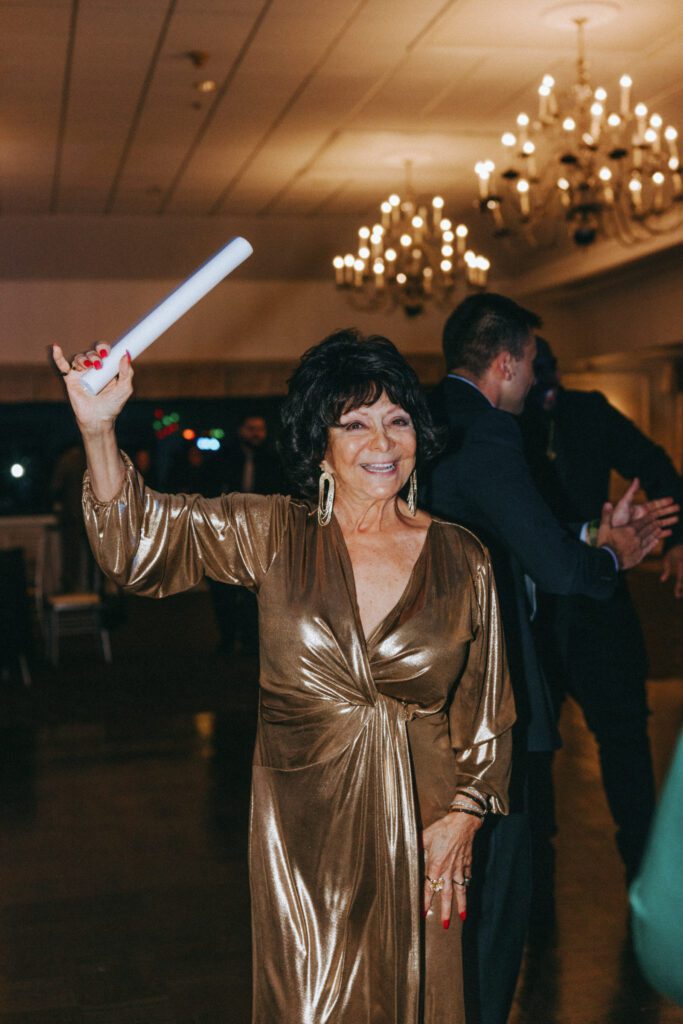 Guest smiling while dancing at classy wedding reception at Black Swan Country Club in Georgetown, Massachusetts.