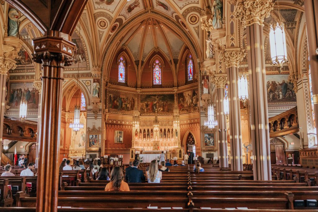 Guest attending romantic wedding ceremony at Quinet Saint John Garden of Our Lady in Massachusetts.