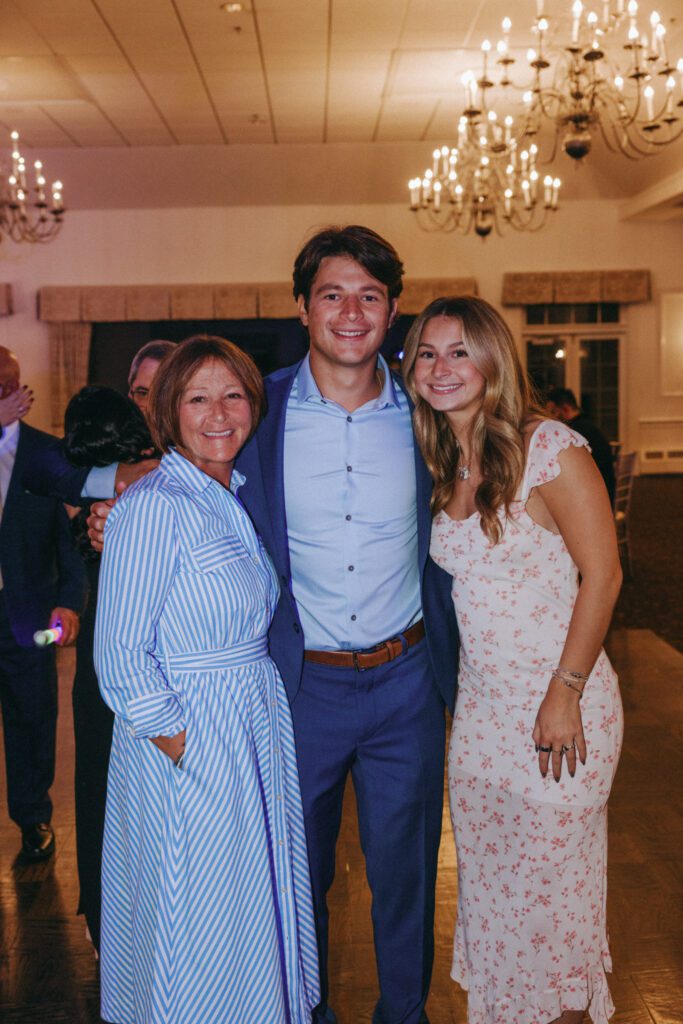 Guests smiling during wedding reception at Black Swan Country Club in Georgetown, Massachusetts.