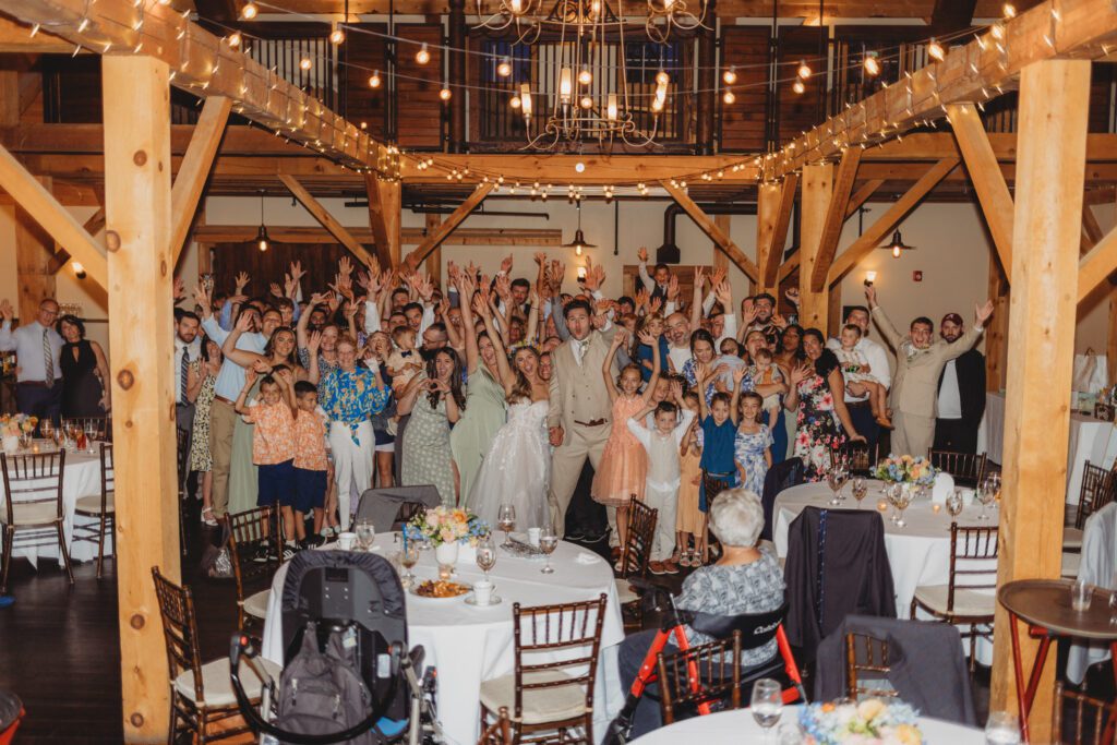 Bride and groom surrounded by all of their guest on dance floor at Peirce Farm Estate in Topsfield, Massachusetts.