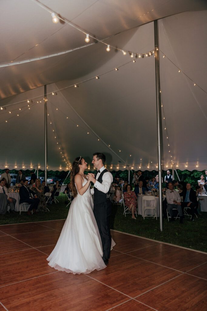 Bride and groom dancing during outdoor wedding reception in Massachusetts.