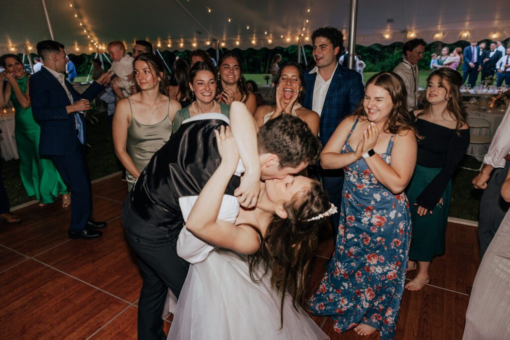 Groom dipping bride during reception in Massachusetts.