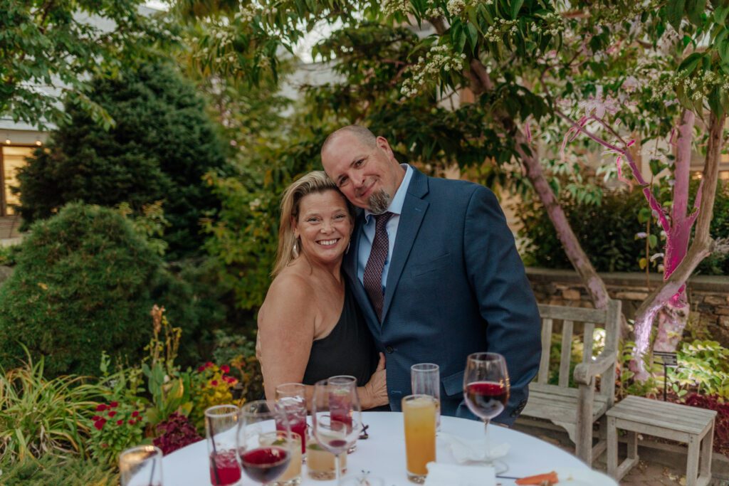Guests smiling during outdoor cocktail hour at Tower Hill in Boylston, Massachusetts.