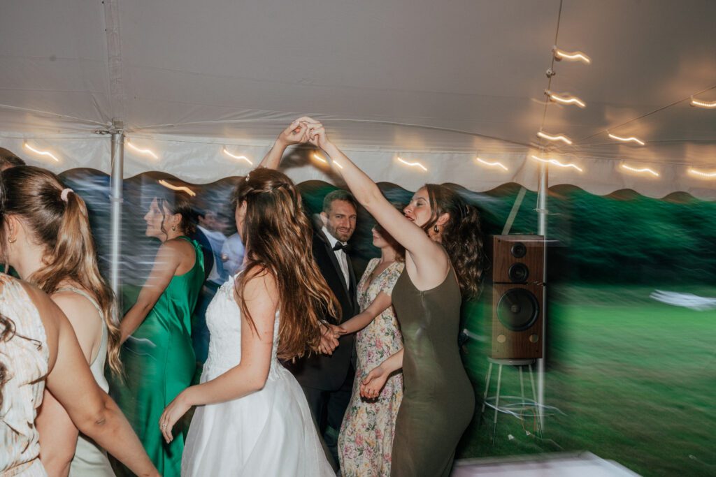 Bride spinning on the dance floor during wedding reception in Massachusetts.