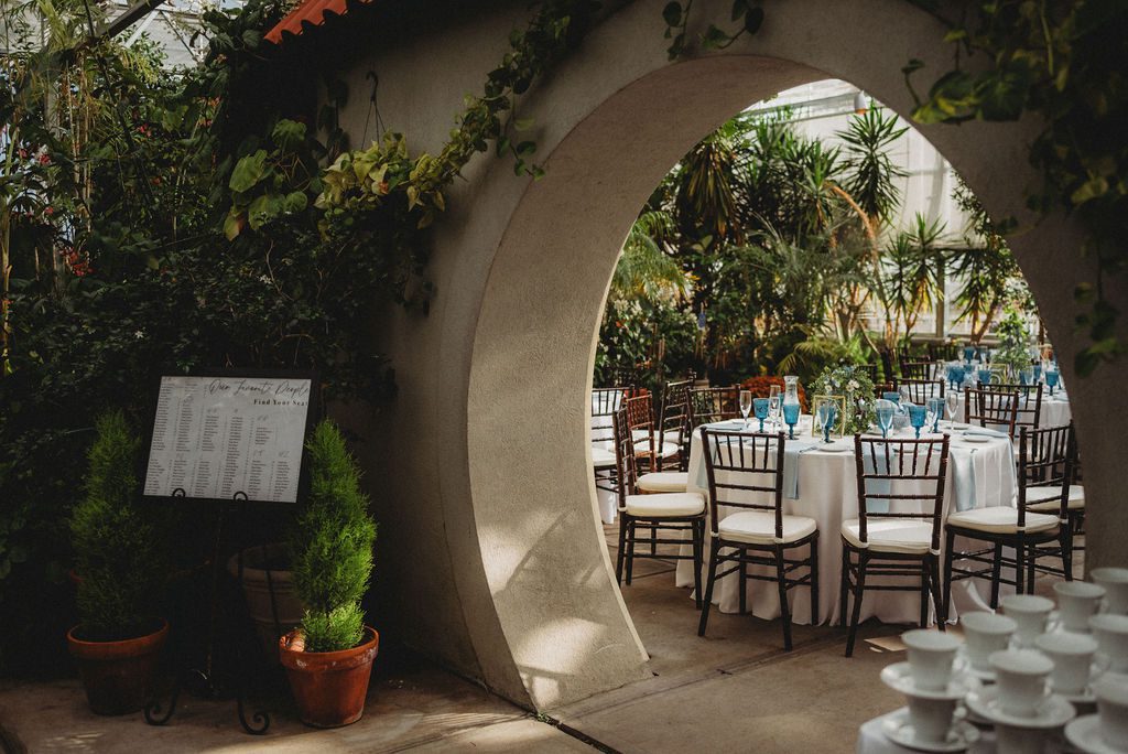 Archway in greenhouse next to wedding set up tables in Roger Williams Botanical Garden Park in Providence Rhode Island.