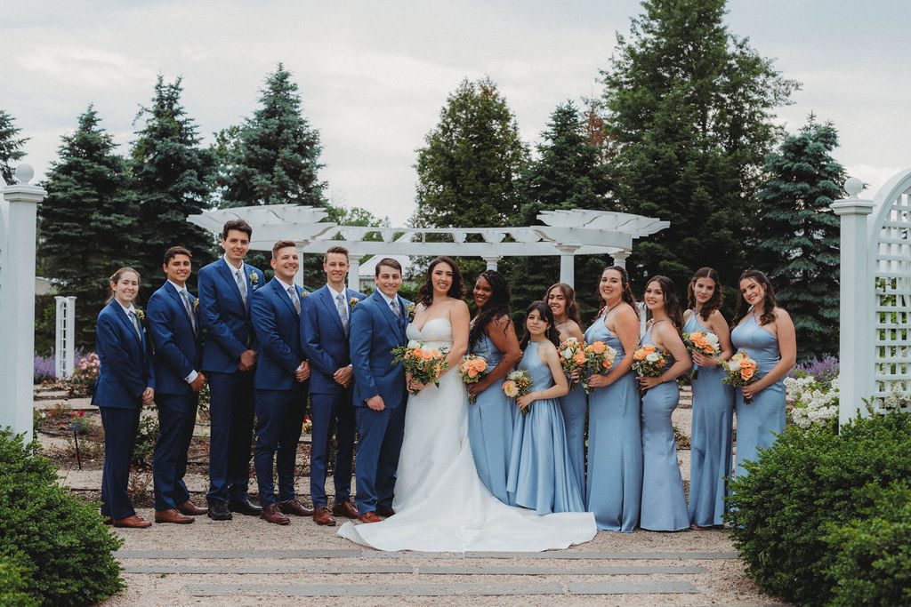 Whimsical bridal party photos in rose garden at Roger Williams Botanical Garden Park in Providence, Rhode Island.