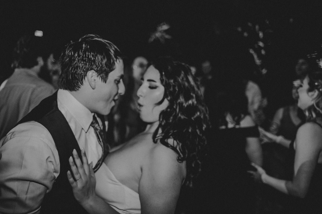 Bride and groom romantically dancing during reception at Roger Williams Botanical Garden Park in Providence, Rhode Island.