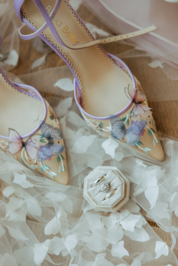 Brides whimsical purple bridal shoes and ring in ring boxes at The Conner Center in Dover, Massachusetts.